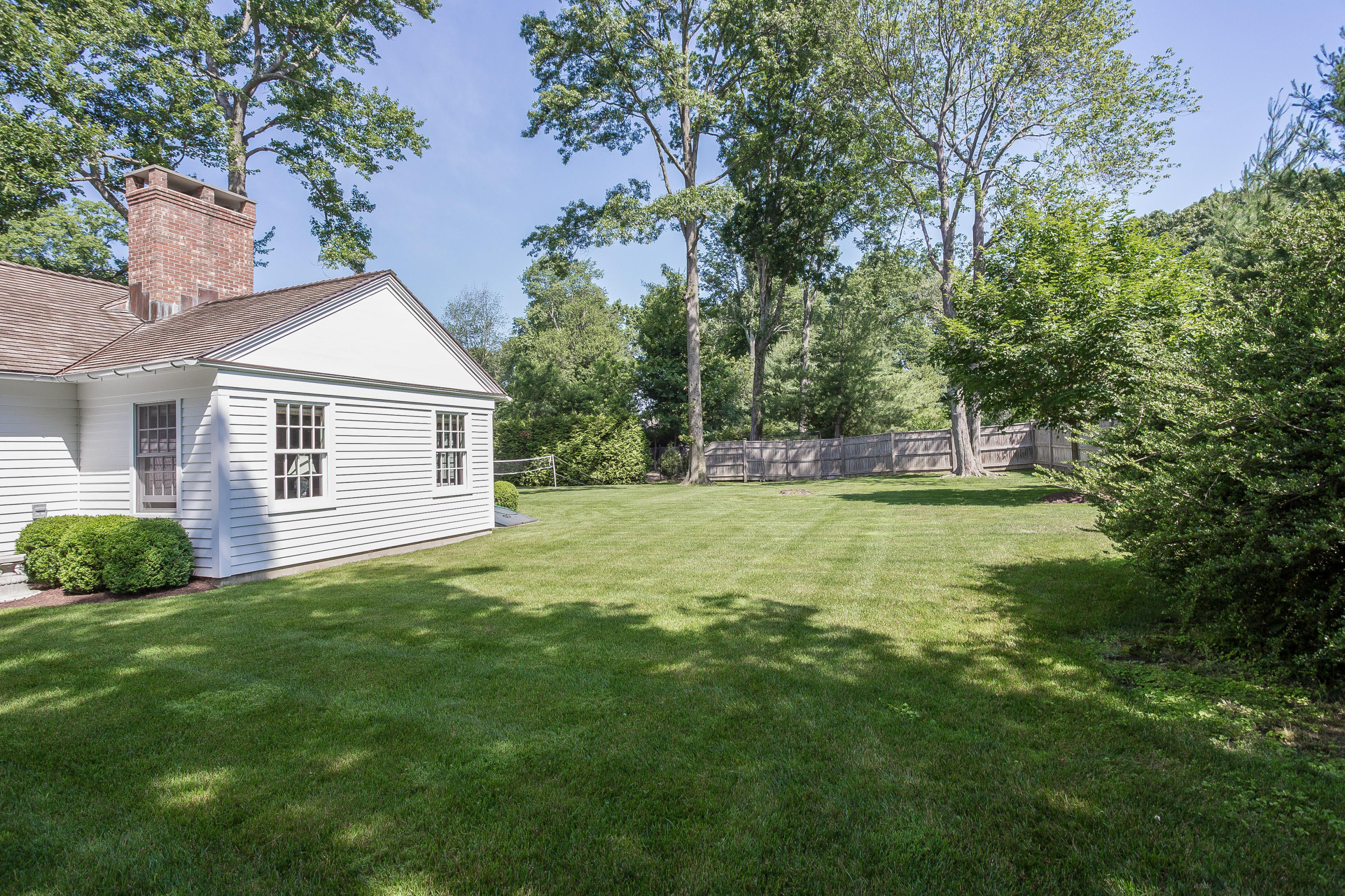 256 Brookside Road Darien, CT 06820 - Photo 59 of 66 a front view of a house with a yard