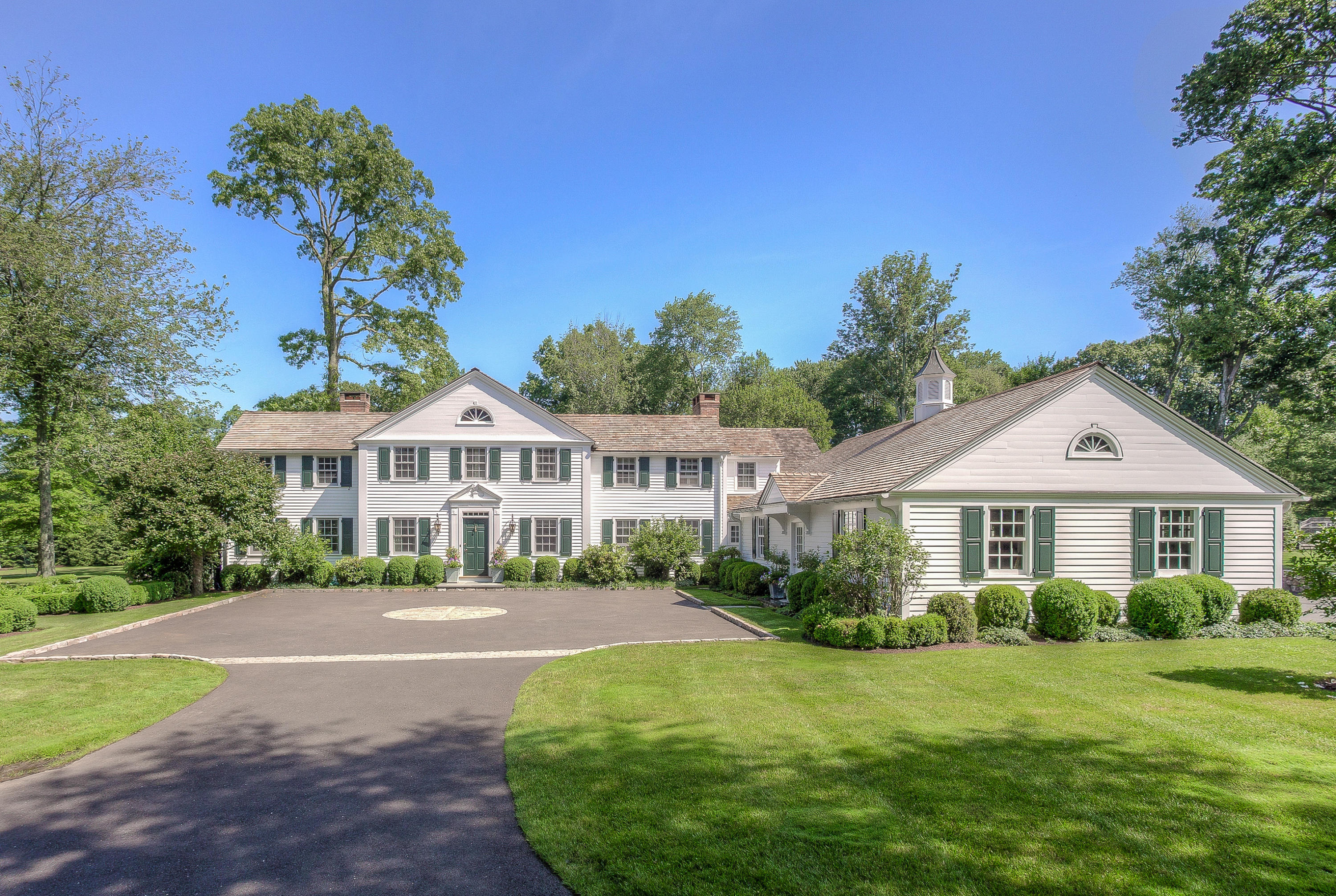 256 Brookside Road Darien, CT 06820 - Photo 6 of 66 a front view of a house with a garden
