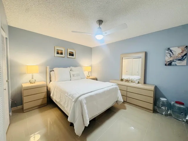 a bed room with a bed and a chandelier