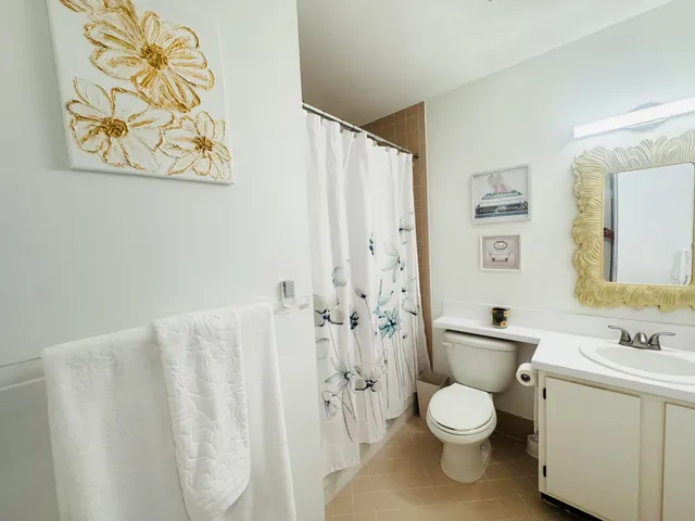 a white toilet sitting next to a bathroom sink