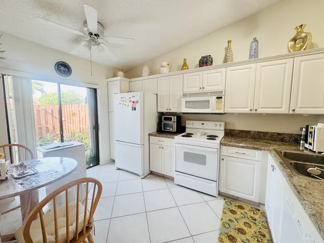 a kitchen with a stove a sink and a refrigerator