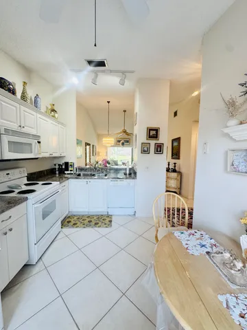 a kitchen with stainless steel appliances kitchen island granite countertop a sink and cabinets