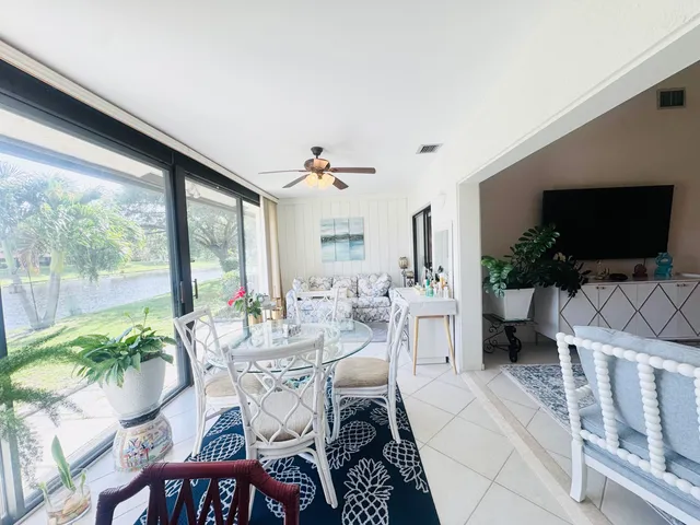 a view of a livingroom with furniture window and a flat screen tv