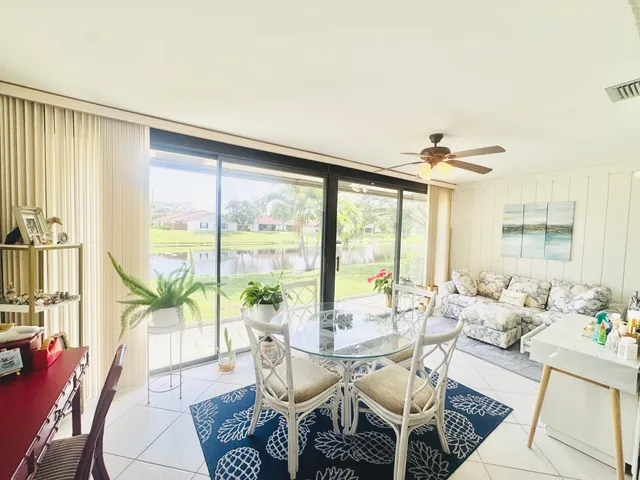 a dining room with furniture a chandelier and wooden floor