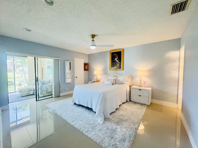 a bedroom with a bed and large glass door