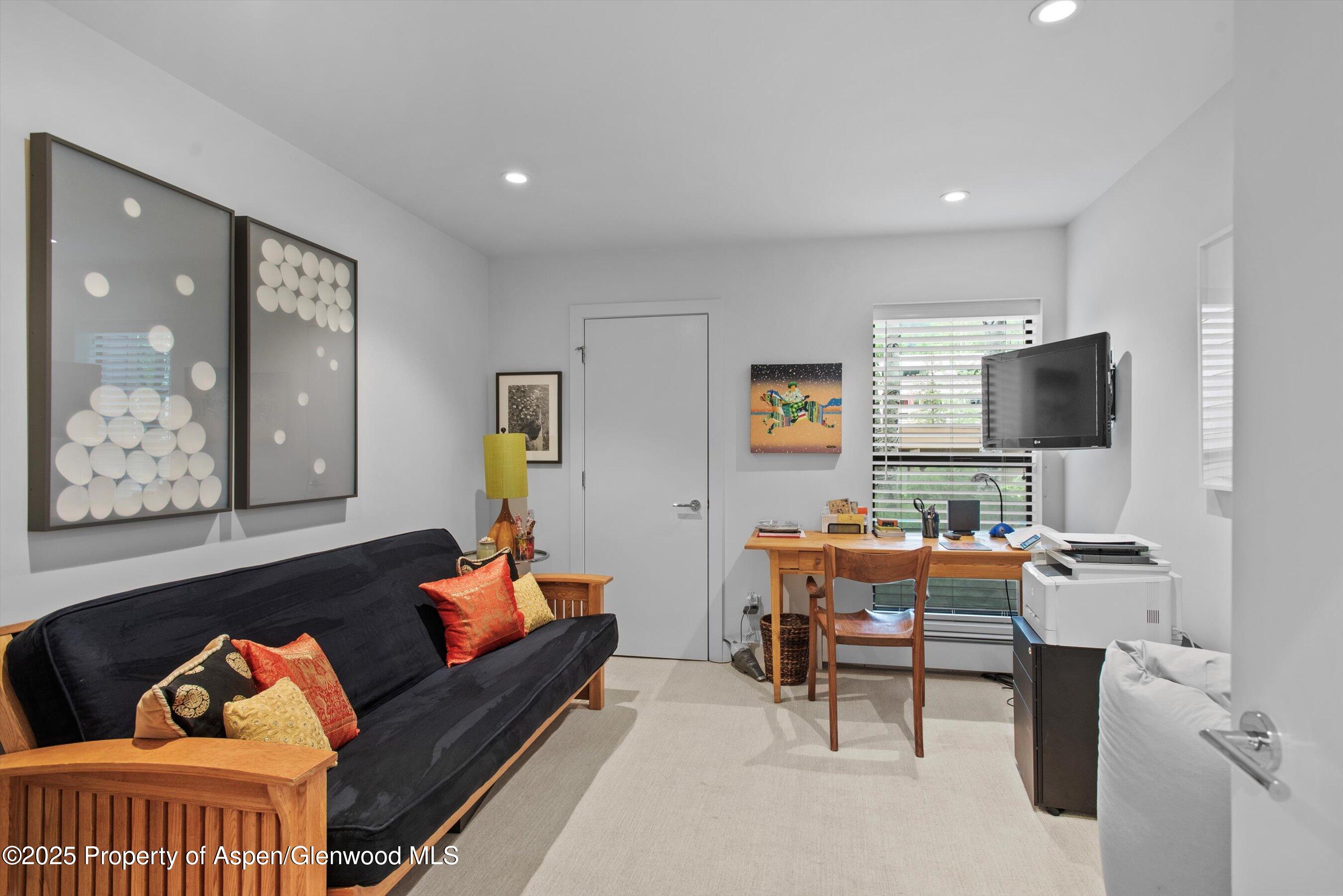 155 Lone Pine Road, Unit 8 Aspen, CO 81611 - Photo 15 of 36 a reading room with furniture and wooden floor