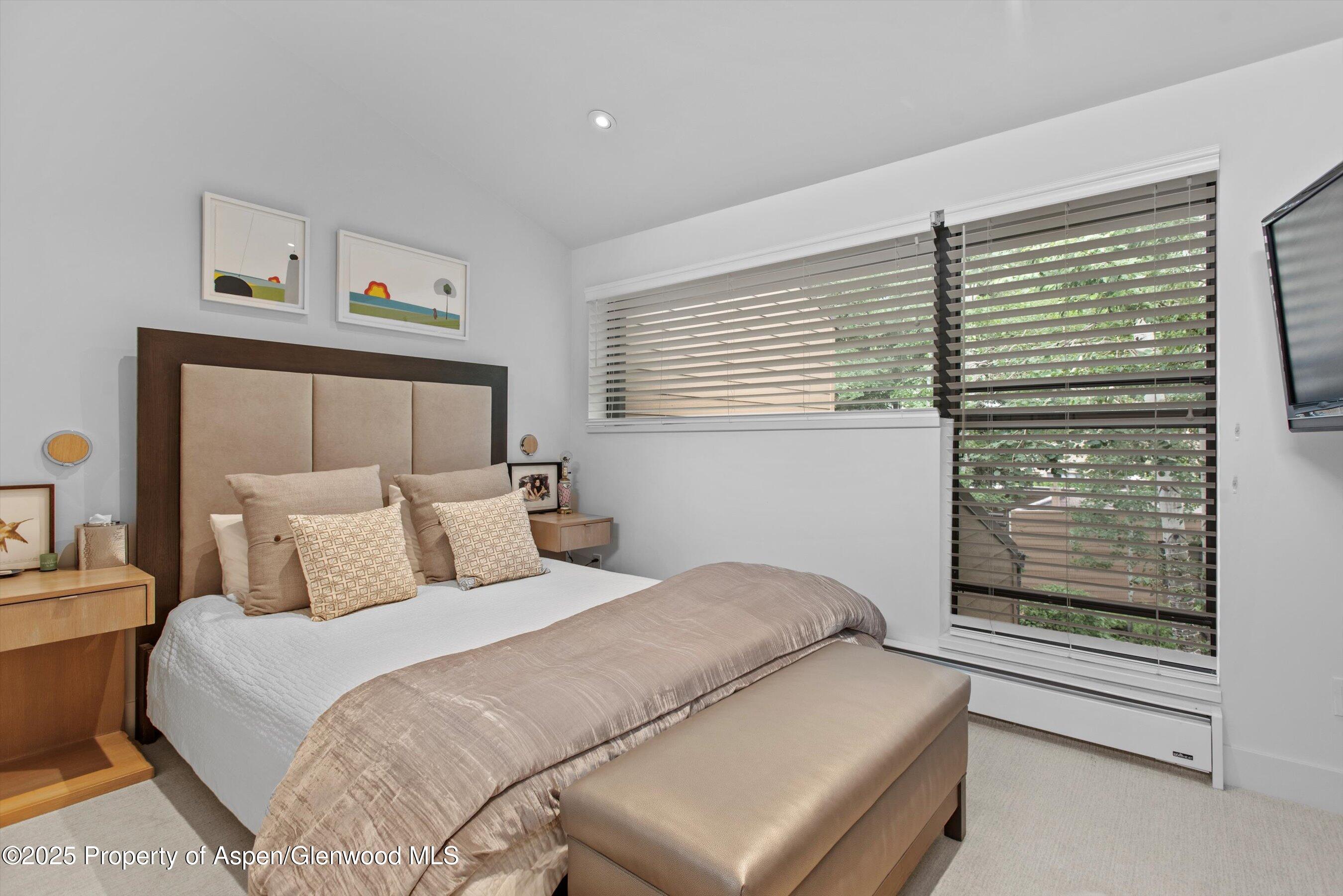 155 Lone Pine Road, Unit 8 Aspen, CO 81611 - Photo 18 of 36 a bedroom with a bed and a window