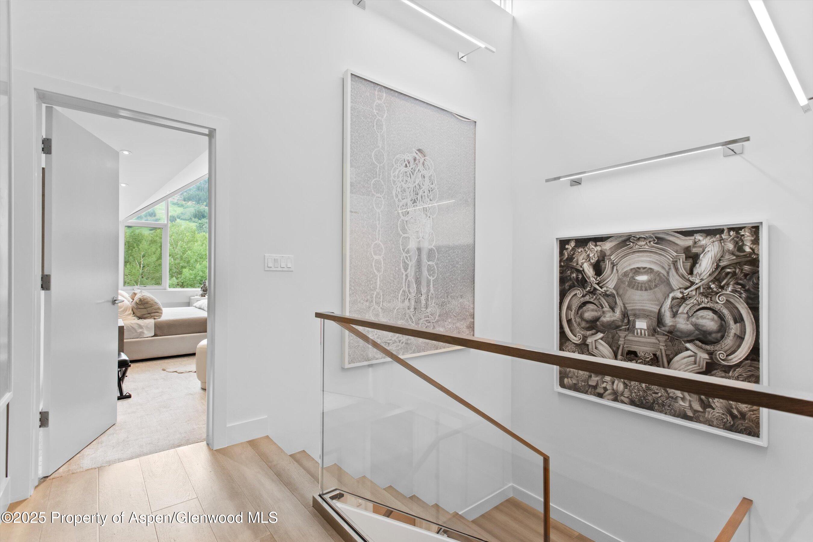 155 Lone Pine Road, Unit 8 Aspen, CO 81611 - Photo 21 of 36 a view of a hallway with couch and wooden floor
