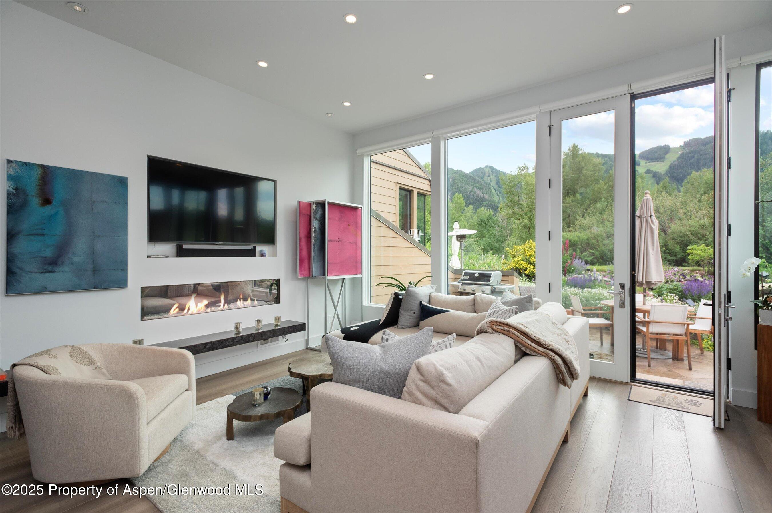 155 Lone Pine Road, Unit 8 Aspen, CO 81611 - Photo 5 of 36 a living room with furniture and a flat screen tv