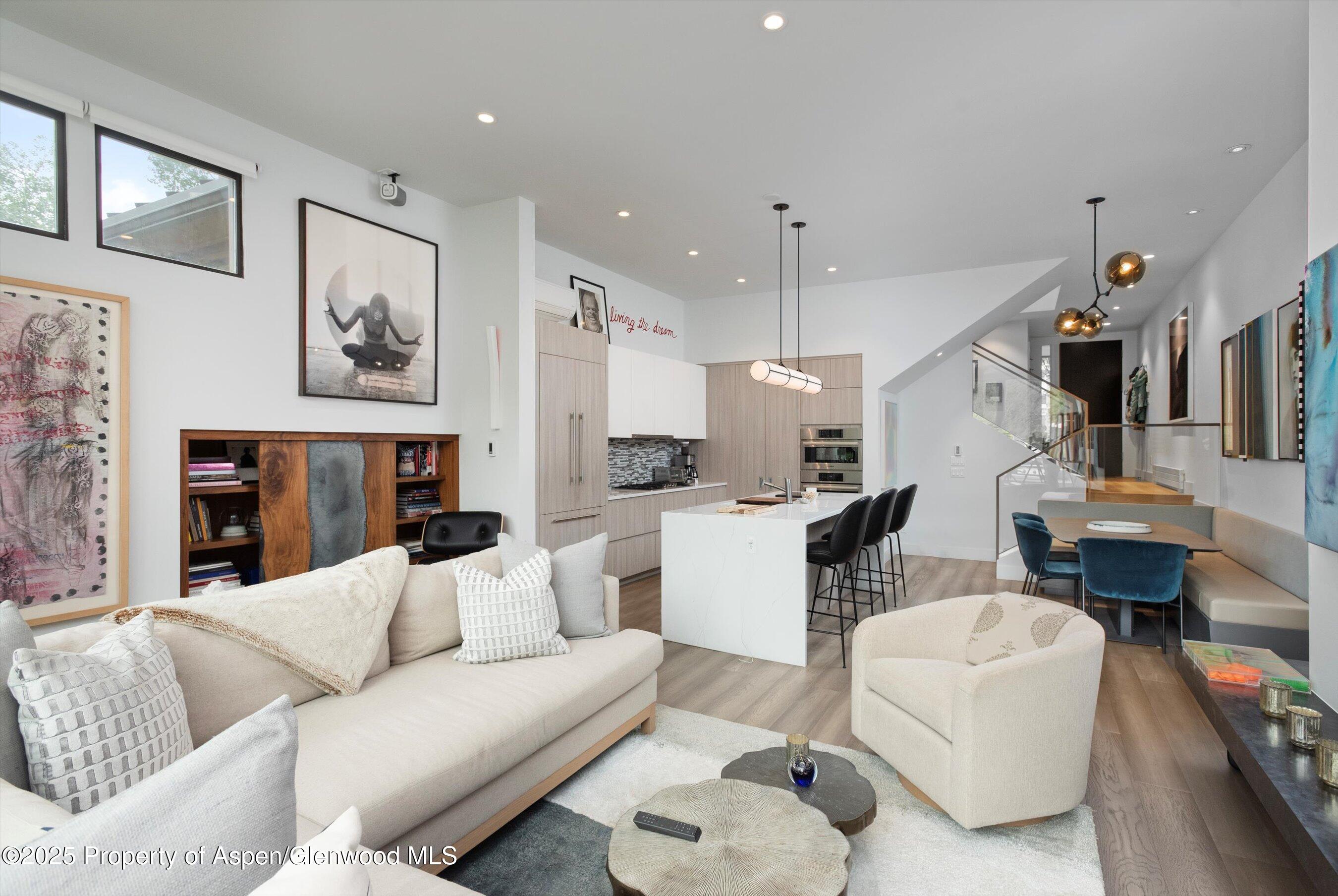 155 Lone Pine Road, Unit 8 Aspen, CO 81611 - Photo 7 of 36 a living room with furniture kitchen view and a chandelier
