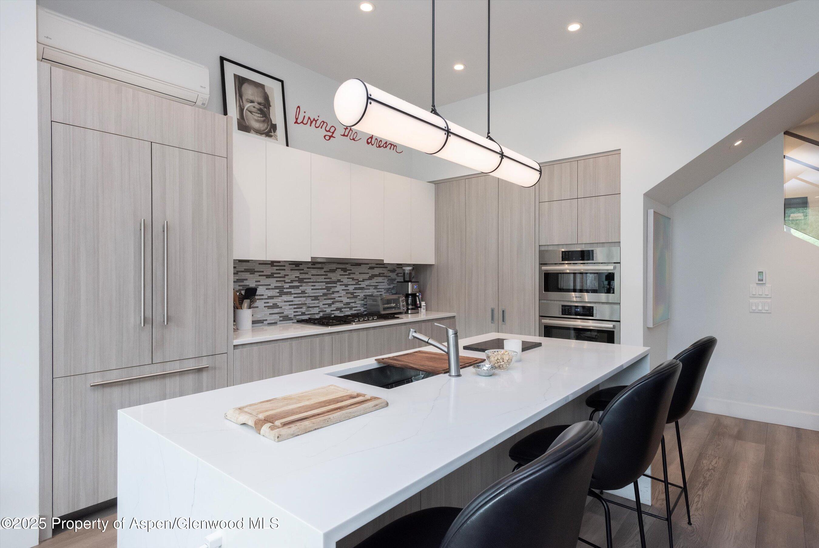 155 Lone Pine Road, Unit 8 Aspen, CO 81611 - Photo 8 of 36 a kitchen with a table and chairs in it