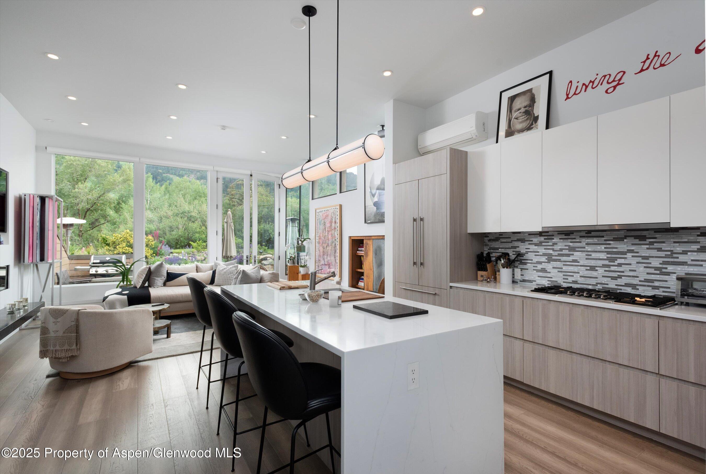 155 Lone Pine Road, Unit 8 Aspen, CO 81611 - Photo 9 of 36 a kitchen with stainless steel appliances kitchen island granite countertop a sink and a stove top oven