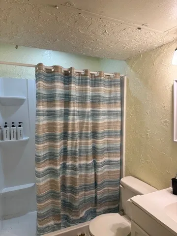 a bathroom with a shower curtain
