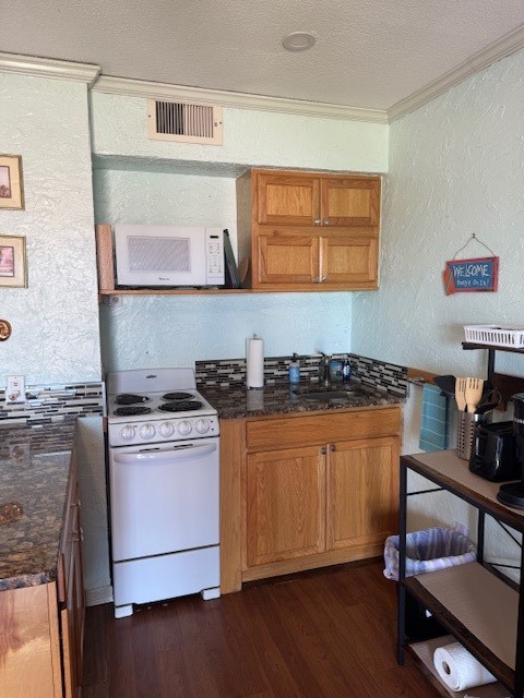 3938 Surfside Boulevard, Unit 1339 Corpus Christi, TX 78402 - Photo 6 of 13 a kitchen with stainless steel appliances granite countertop a stove and a refrigerator
