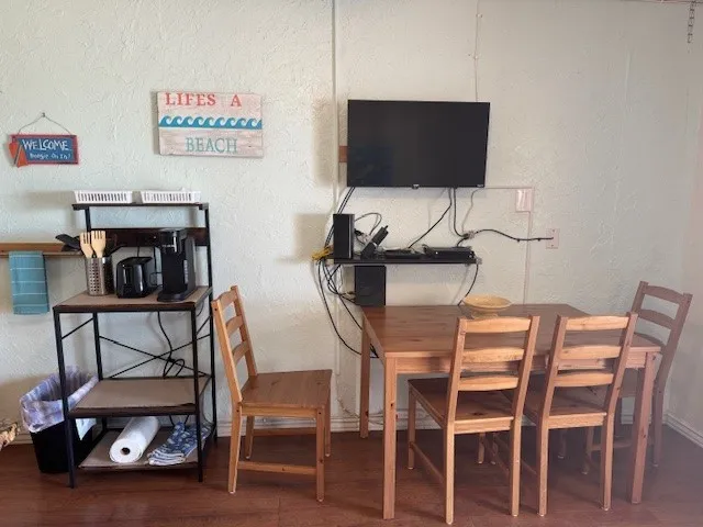a dining room with furniture and a flat screen tv