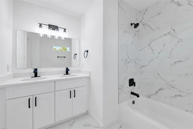 a bathroom with a bathtub sink a mirror and shower