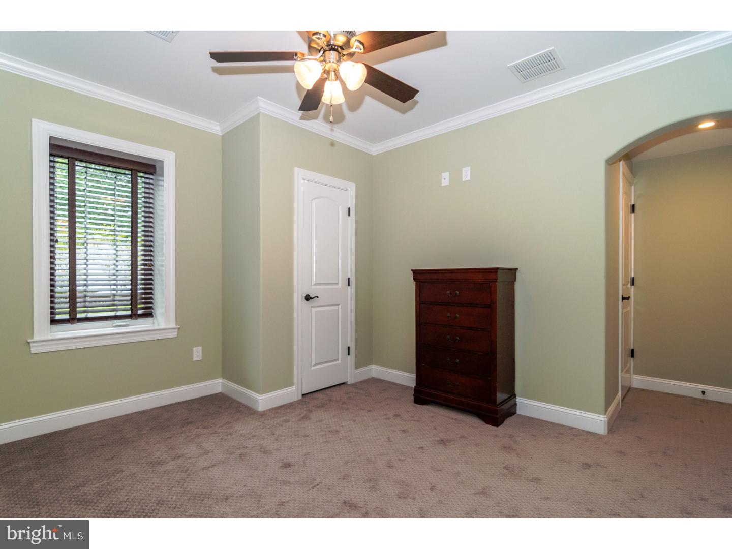 241 Shoemaker Road Huntingdon Valley, PA 19006 - Photo 21 of 25 a view of an empty room with a ceiling fan and a window