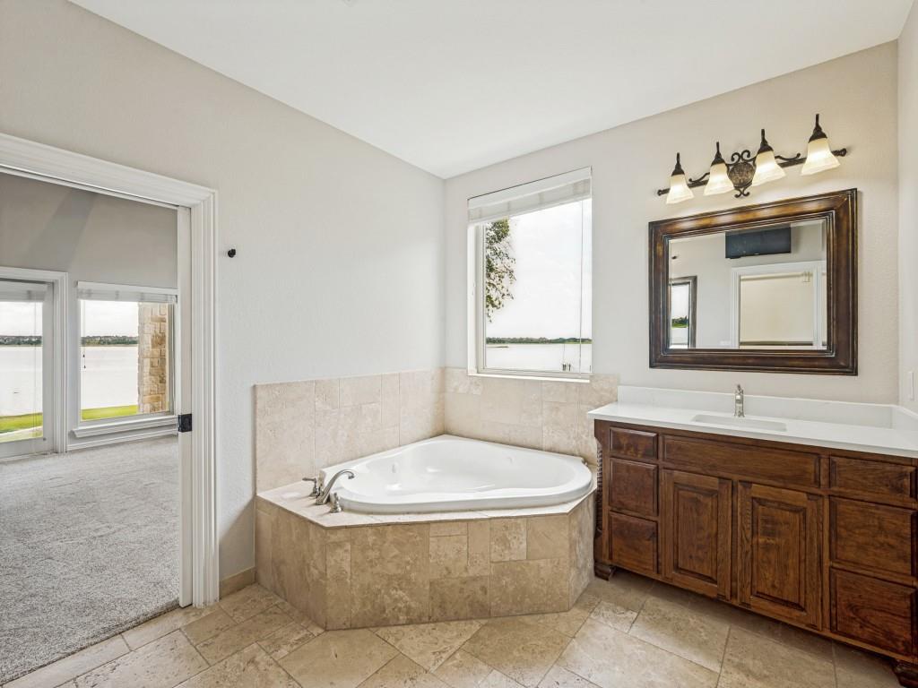 5975 Diamond Spur Frisco, TX 75036 - Photo 19 of 40 a bathroom with a tub sink and mirror