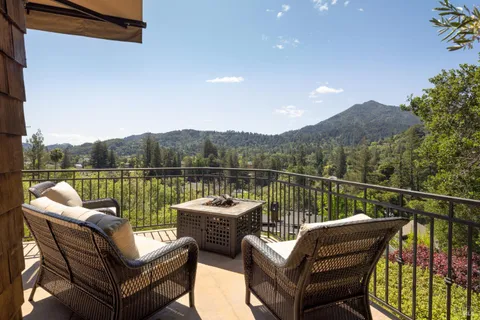 a view of a balcony with couches and wooden floor
