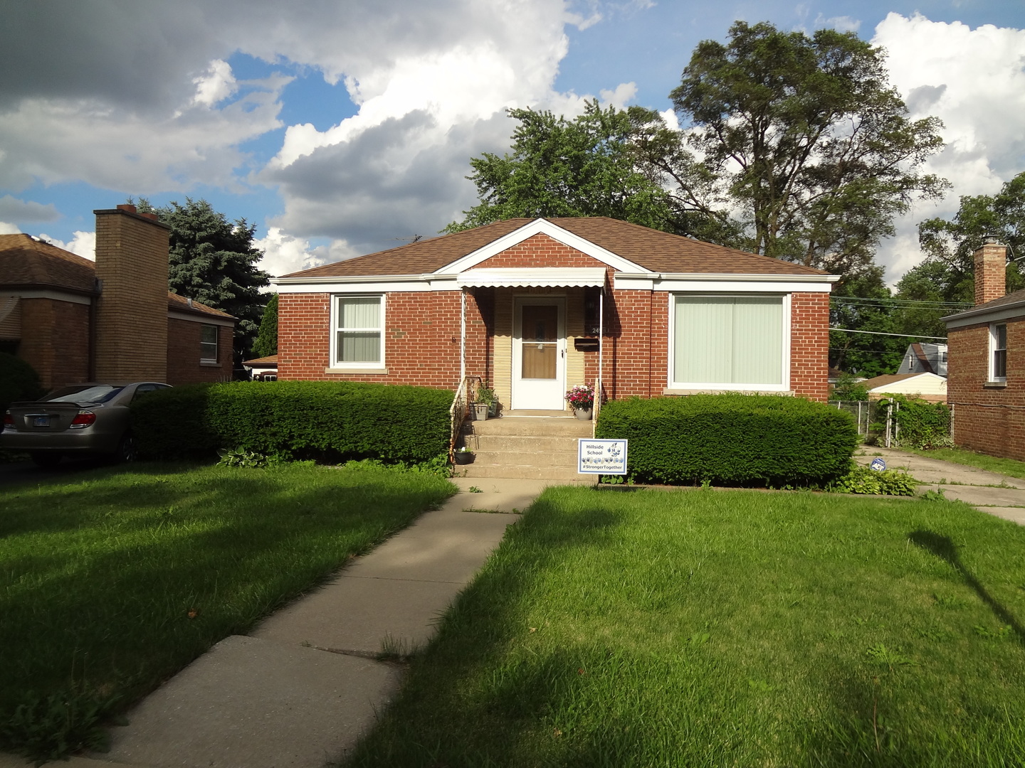 245 North Wolf Road Hillside, IL 60162 - Photo 1 of 21 a front view of a house with a yard