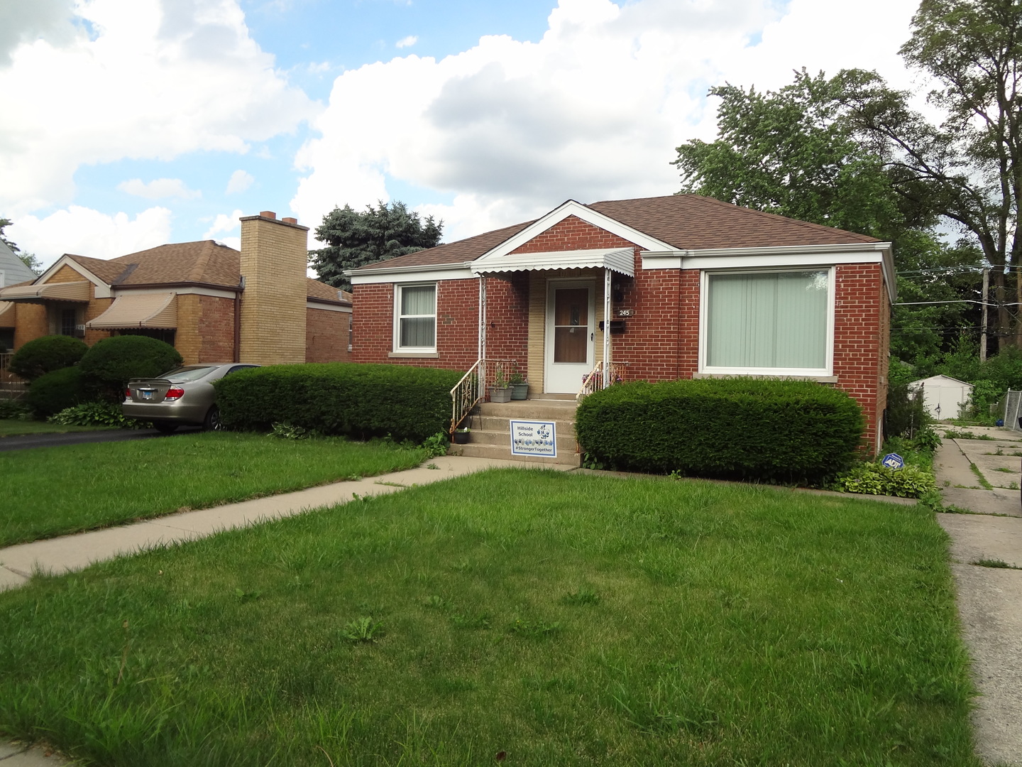 245 North Wolf Road Hillside, IL 60162 - Photo 2 of 21 a front view of a house with a garden