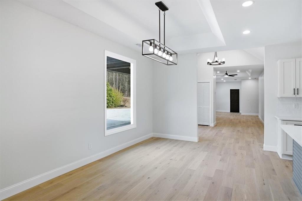 4911 Lower Jersey Road Oxford, GA 30054 - Photo 11 of 56 a view of a room with wooden floor chandelier and windows