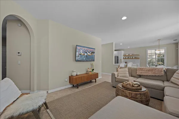 a living room with furniture a window and a flat screen tv