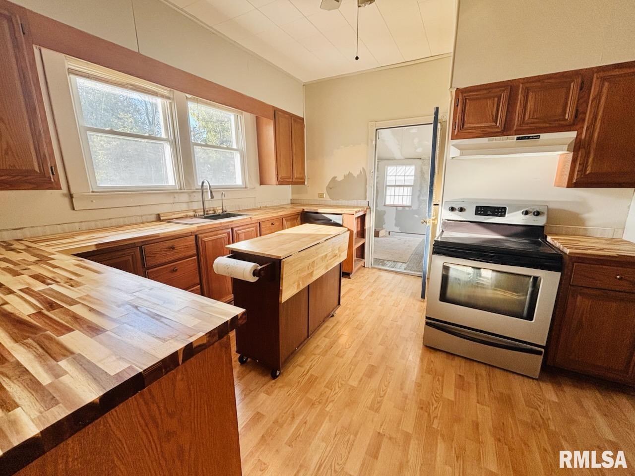 310 West Walnut Street Carbondale, IL 62901 - Photo 4 of 12 a kitchen with stainless steel appliances and wooden cabinets