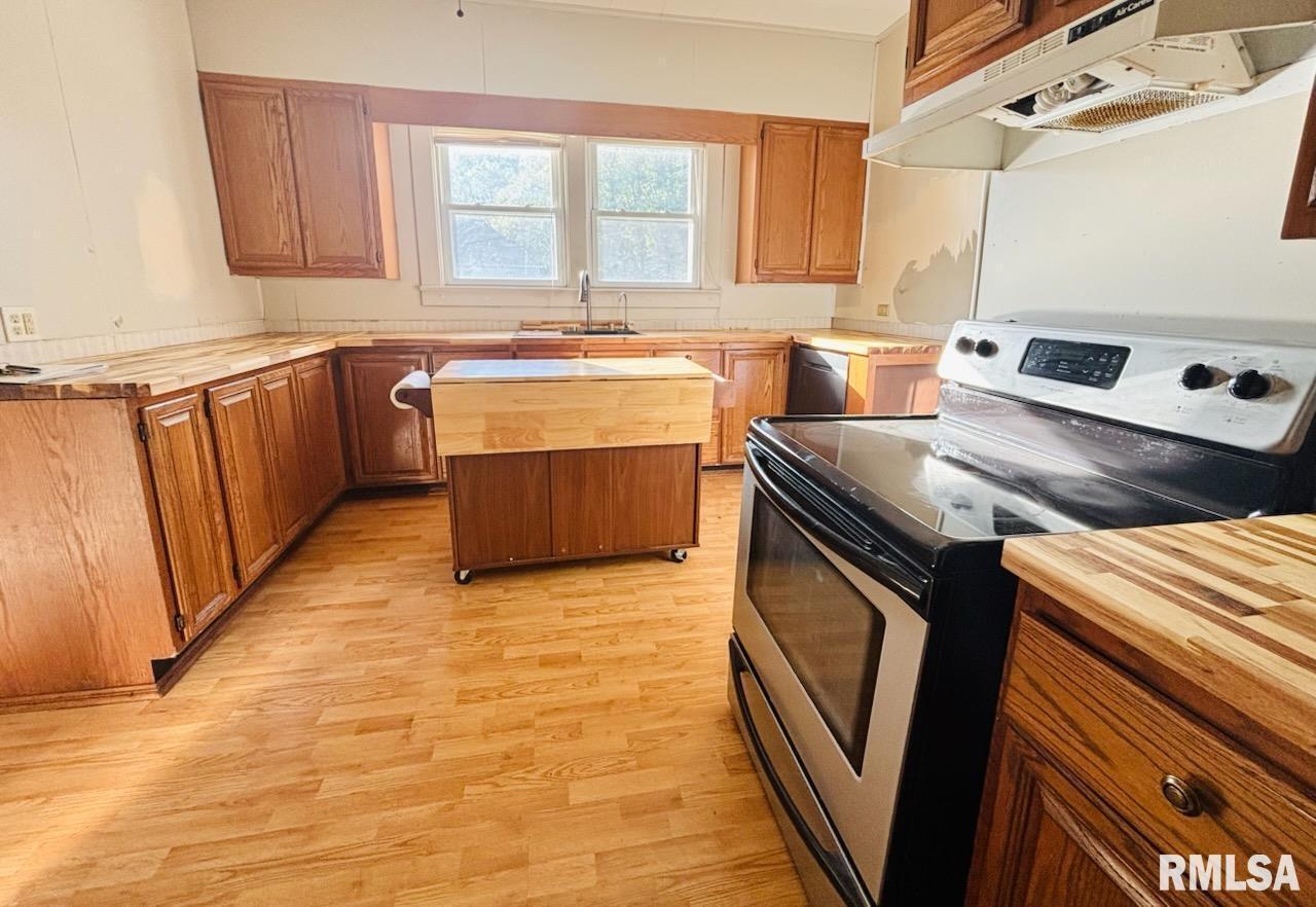 310 West Walnut Street Carbondale, IL 62901 - Photo 5 of 12 a kitchen with a stove sink and cabinets