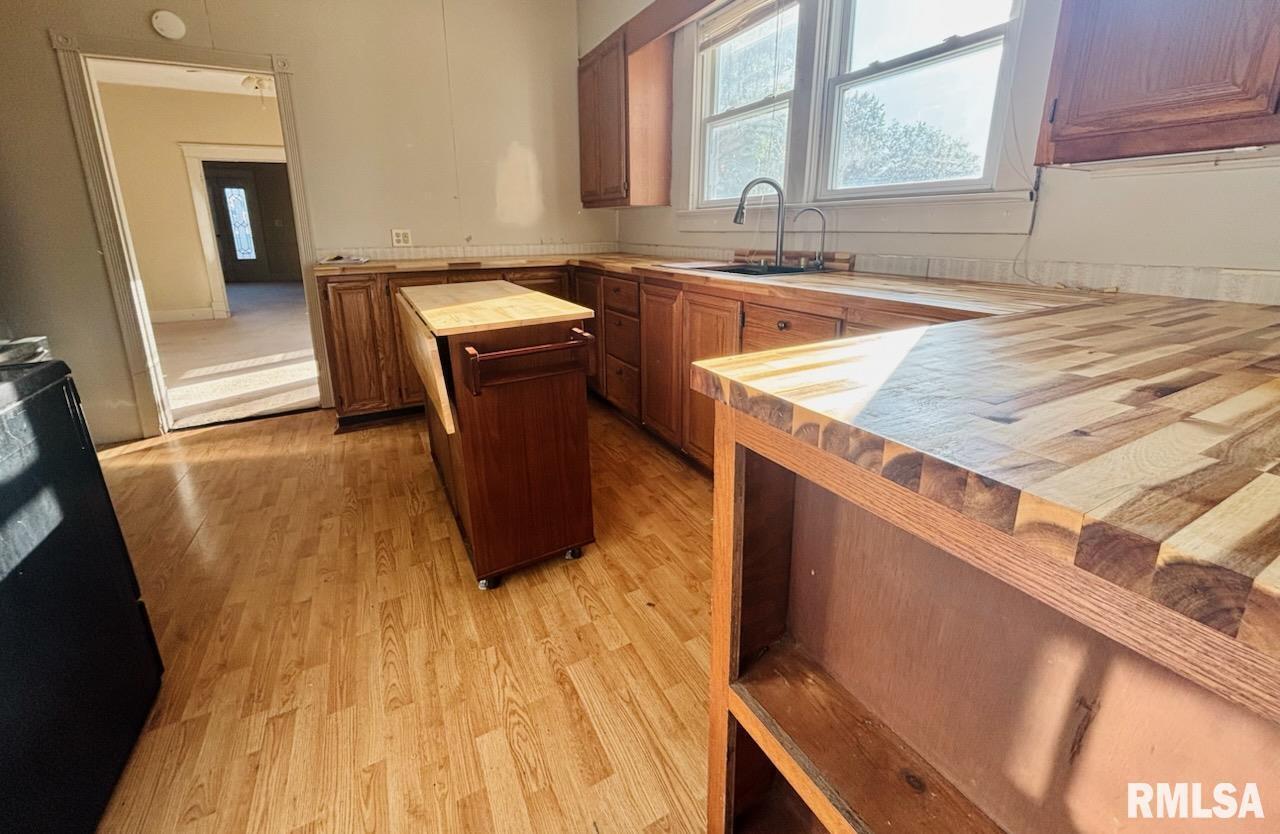 310 West Walnut Street Carbondale, IL 62901 - Photo 6 of 12 a kitchen with sink and wooden cabinets