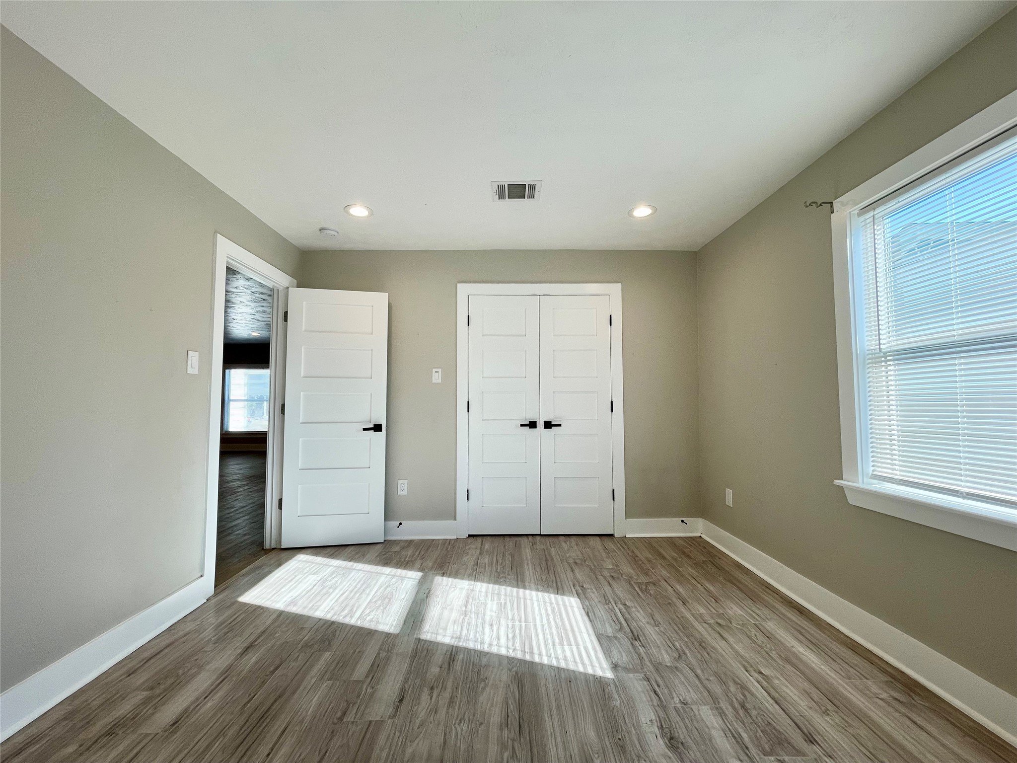 4504 Kingsbury Street Houston, TX 77021 - Photo 12 of 18 a view of a room with wooden floor and windows
