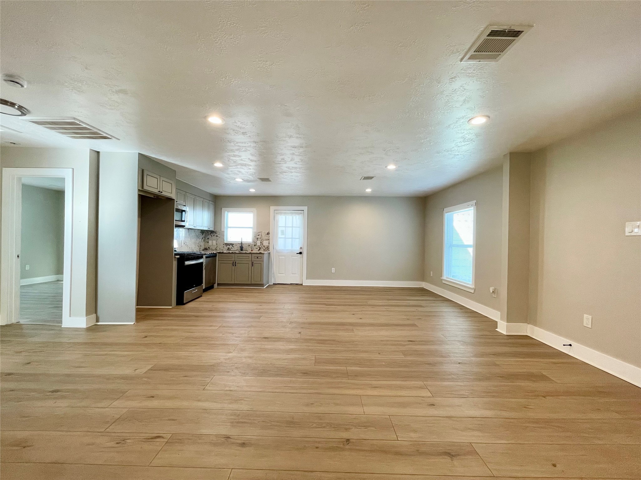 4504 Kingsbury Street Houston, TX 77021 - Photo 3 of 18 a view of empty room with kitchen and window