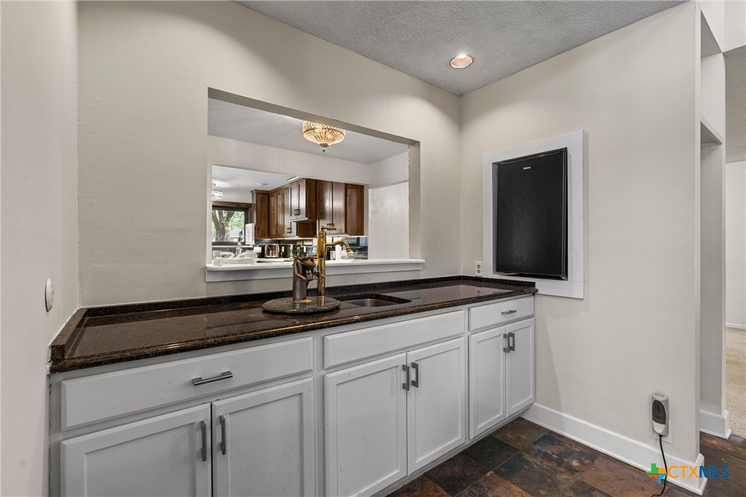 2007 O'Kelley Road Rockdale, TX 76567 - Photo 17 of 40 a bathroom with a granite countertop sink and a mirror
