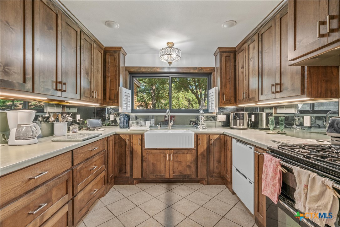 2007 O'Kelley Road Rockdale, TX 76567 - Photo 20 of 40 a kitchen with stainless steel appliances granite countertop a sink stove and cabinets