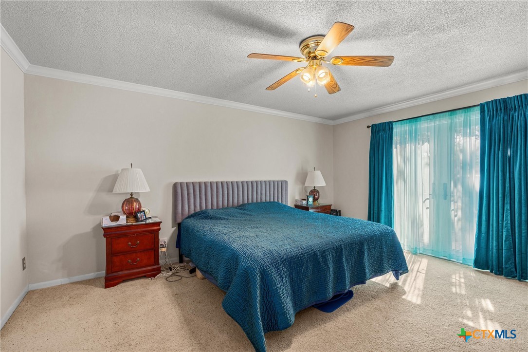 2007 O'Kelley Road Rockdale, TX 76567 - Photo 23 of 40 a bedroom with a bed and a chandelier