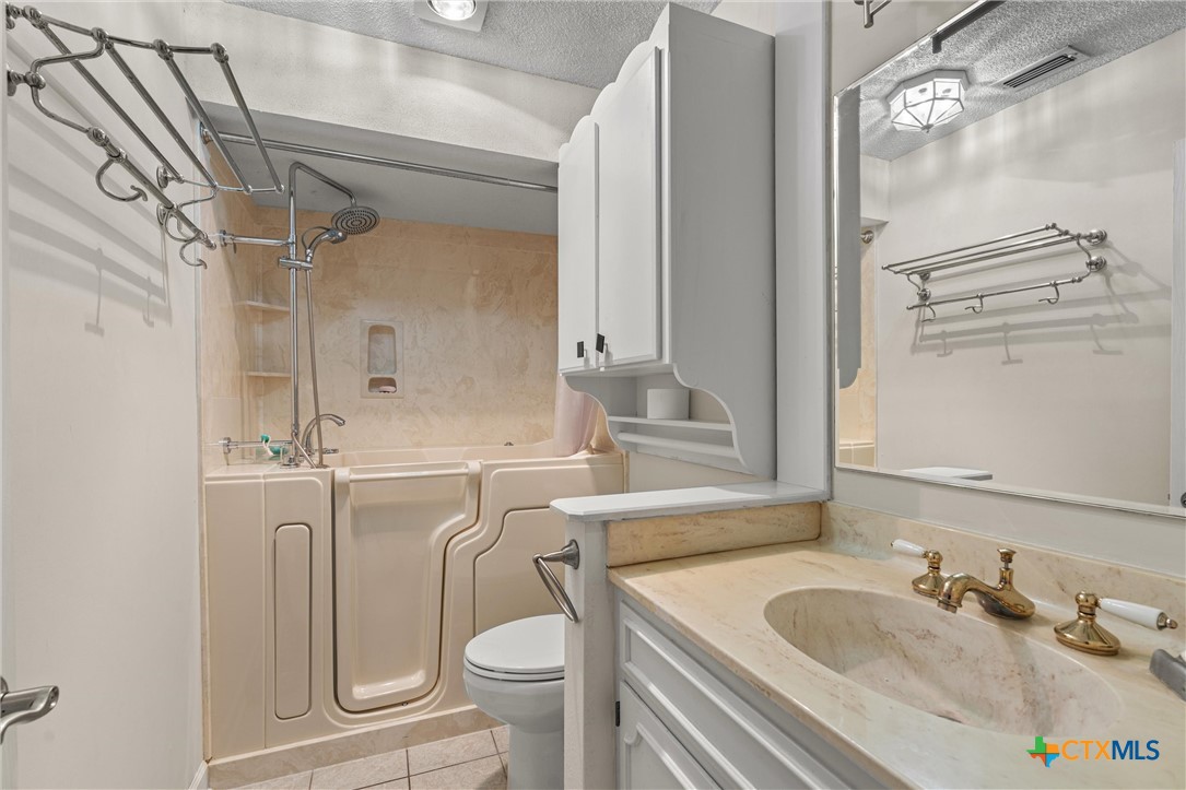 2007 O'Kelley Road Rockdale, TX 76567 - Photo 31 of 40 a bathroom with a granite countertop sink toilet and shower