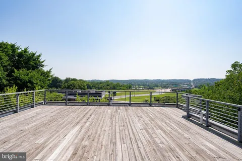 a view of deck with seating and city view