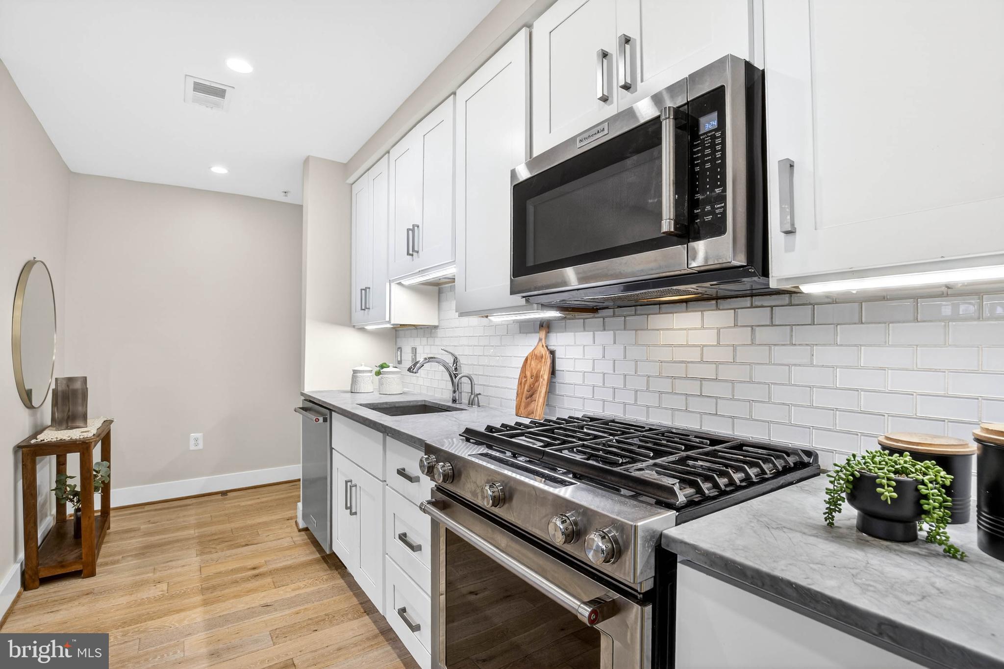 1516 K Street Southeast, Unit 2C Washington, DC 20003 - Photo 6 of 17 a kitchen with a stove and a microwave