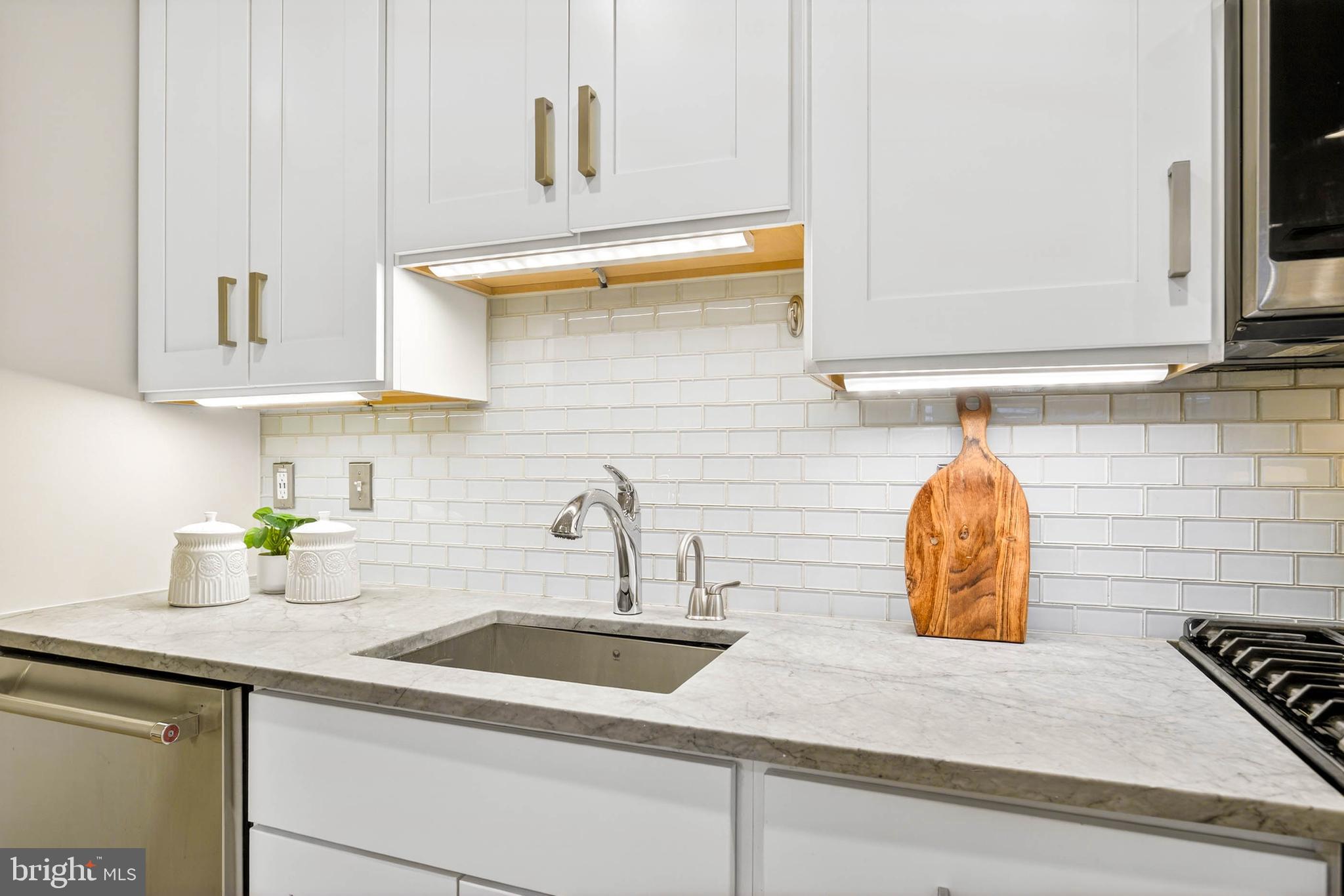 1516 K Street Southeast, Unit 2C Washington, DC 20003 - Photo 8 of 17 a kitchen with a sink and a stove