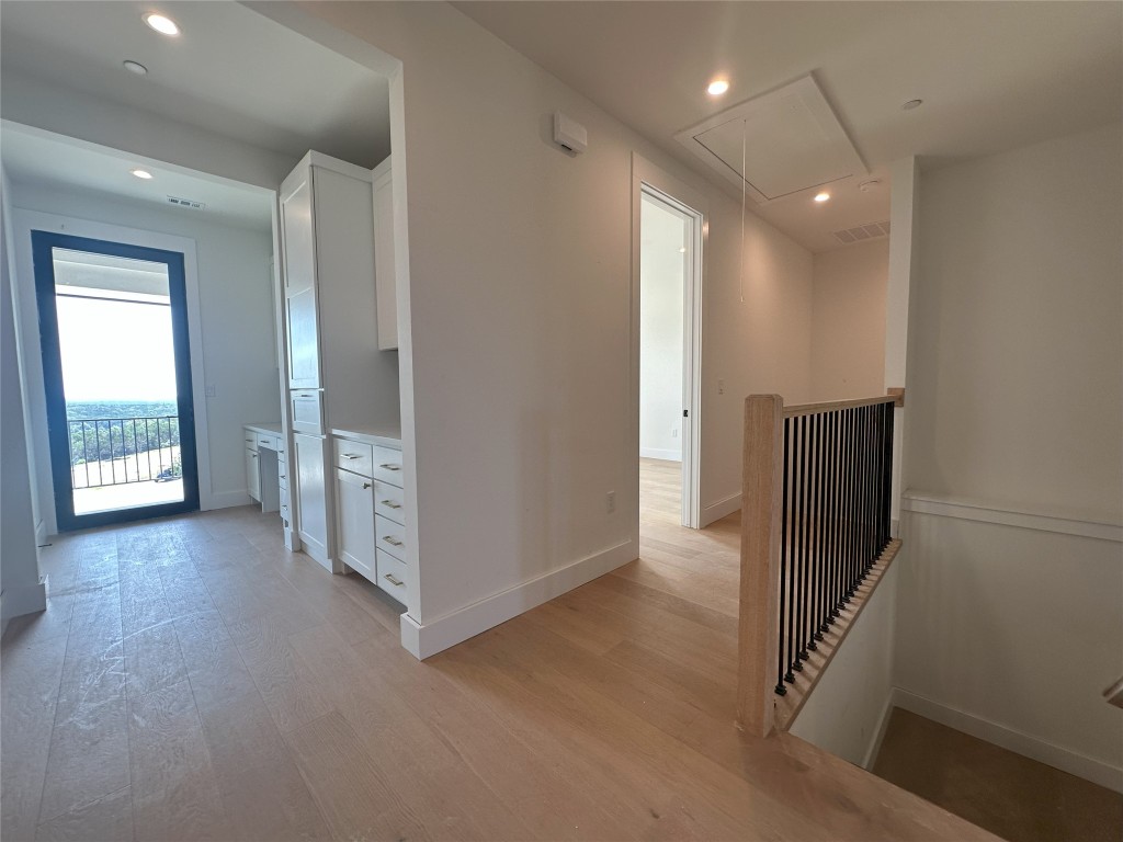 6010 Adhara Pass Austin, TX 78730 - Photo 34 of 40 a view of hallway with stairs and wooden floor