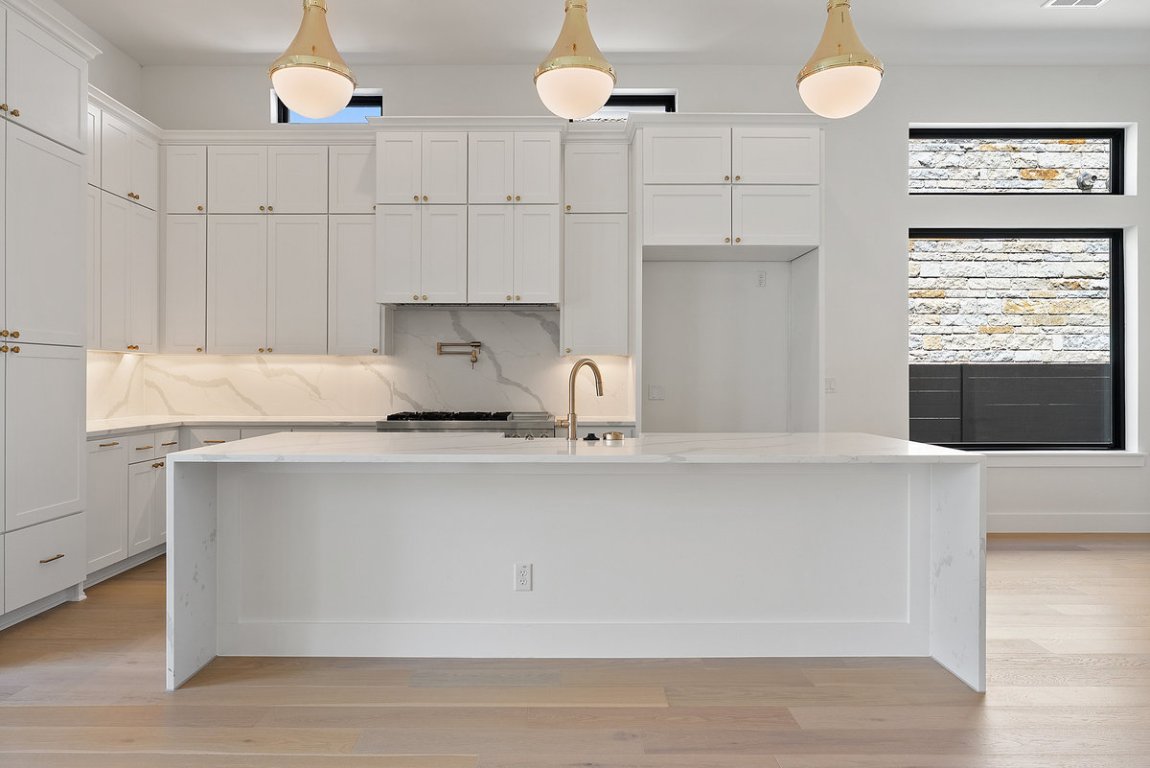 6010 Adhara Pass Austin, TX 78730 - Photo 7 of 40 a kitchen with stainless steel appliances granite countertop a sink a stove and a wooden floors