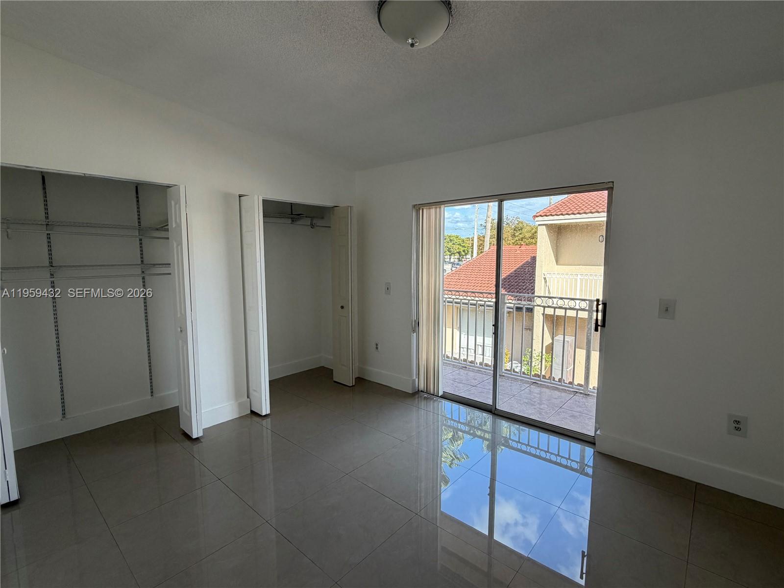 6934 Northwest 166th Terrace, Unit 1402 Miami Lakes, FL 33014 - Photo 12 of 13 an empty room with windows