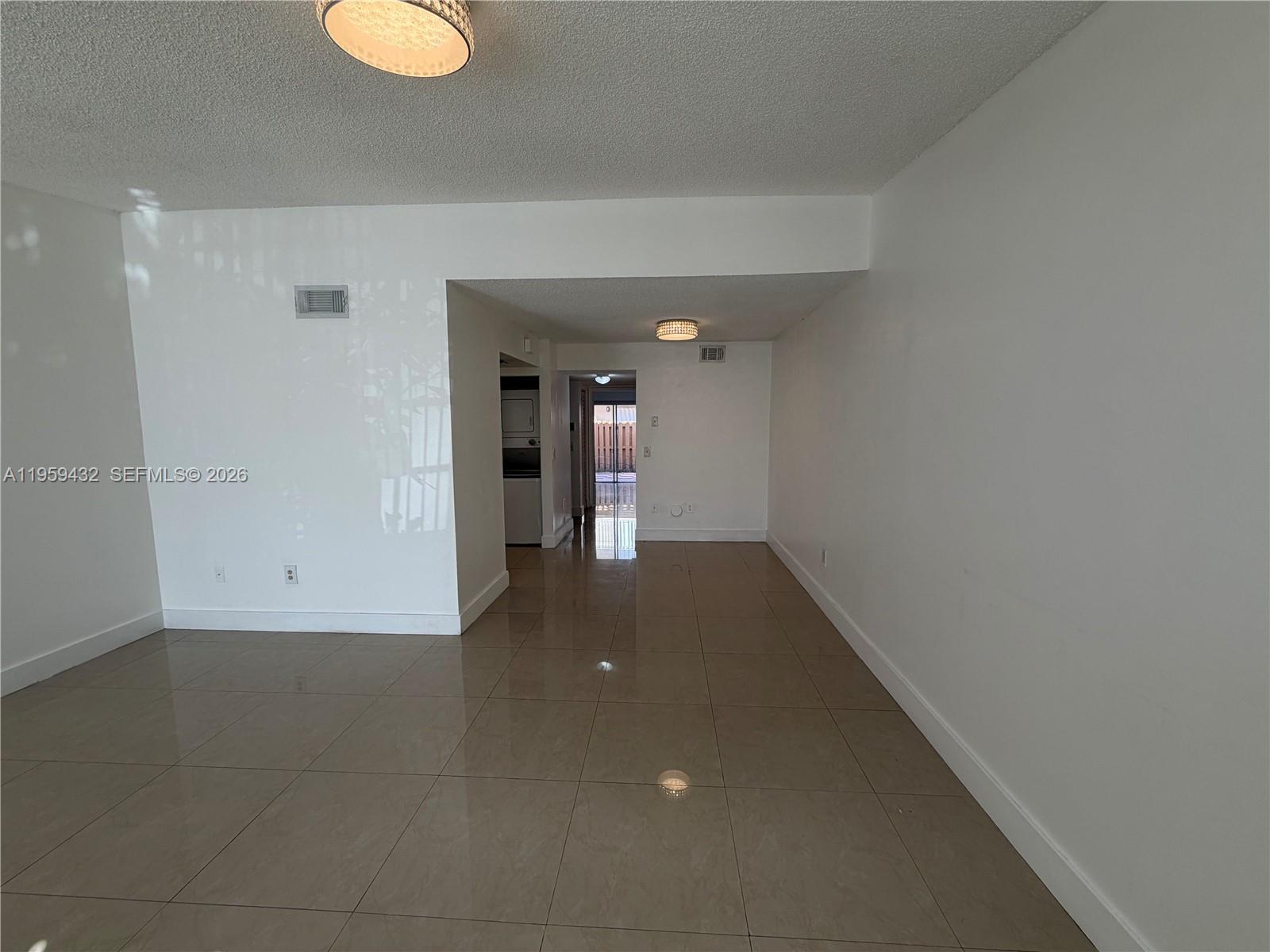 6934 Northwest 166th Terrace, Unit 1402 Miami Lakes, FL 33014 - Photo 3 of 13 a view of a hallway with wooden floor