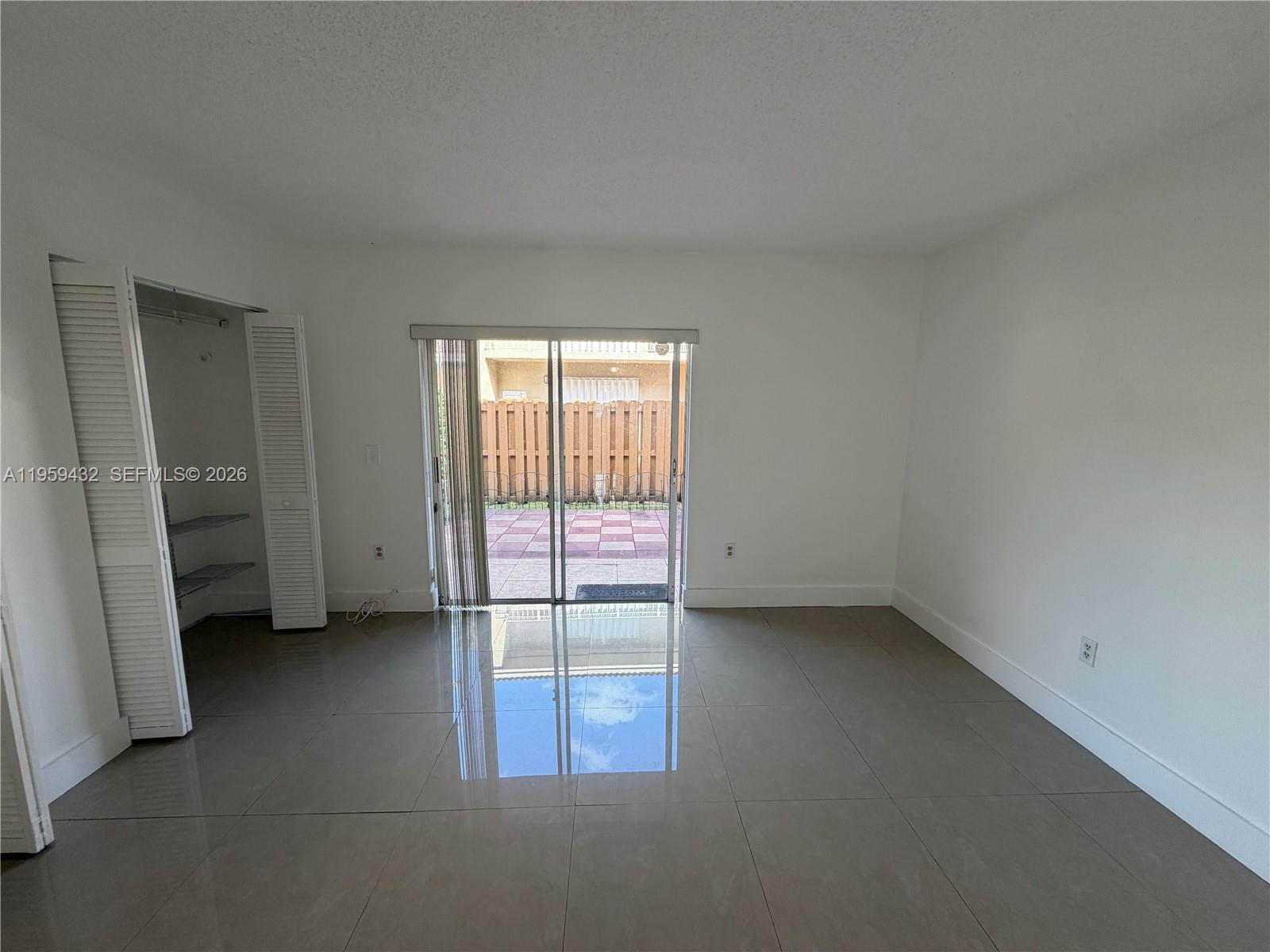 6934 Northwest 166th Terrace, Unit 1402 Miami Lakes, FL 33014 - Photo 8 of 13 an empty room with windows
