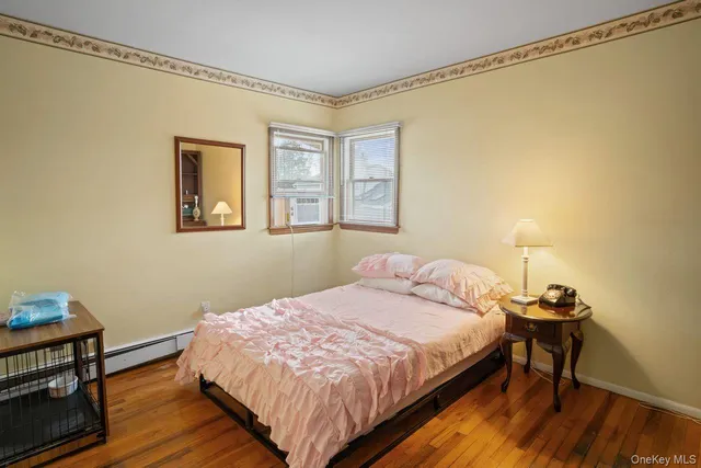 a bedroom with a bed table and a window