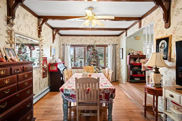 a view of a dining room with furniture wooden floor and chandelier
