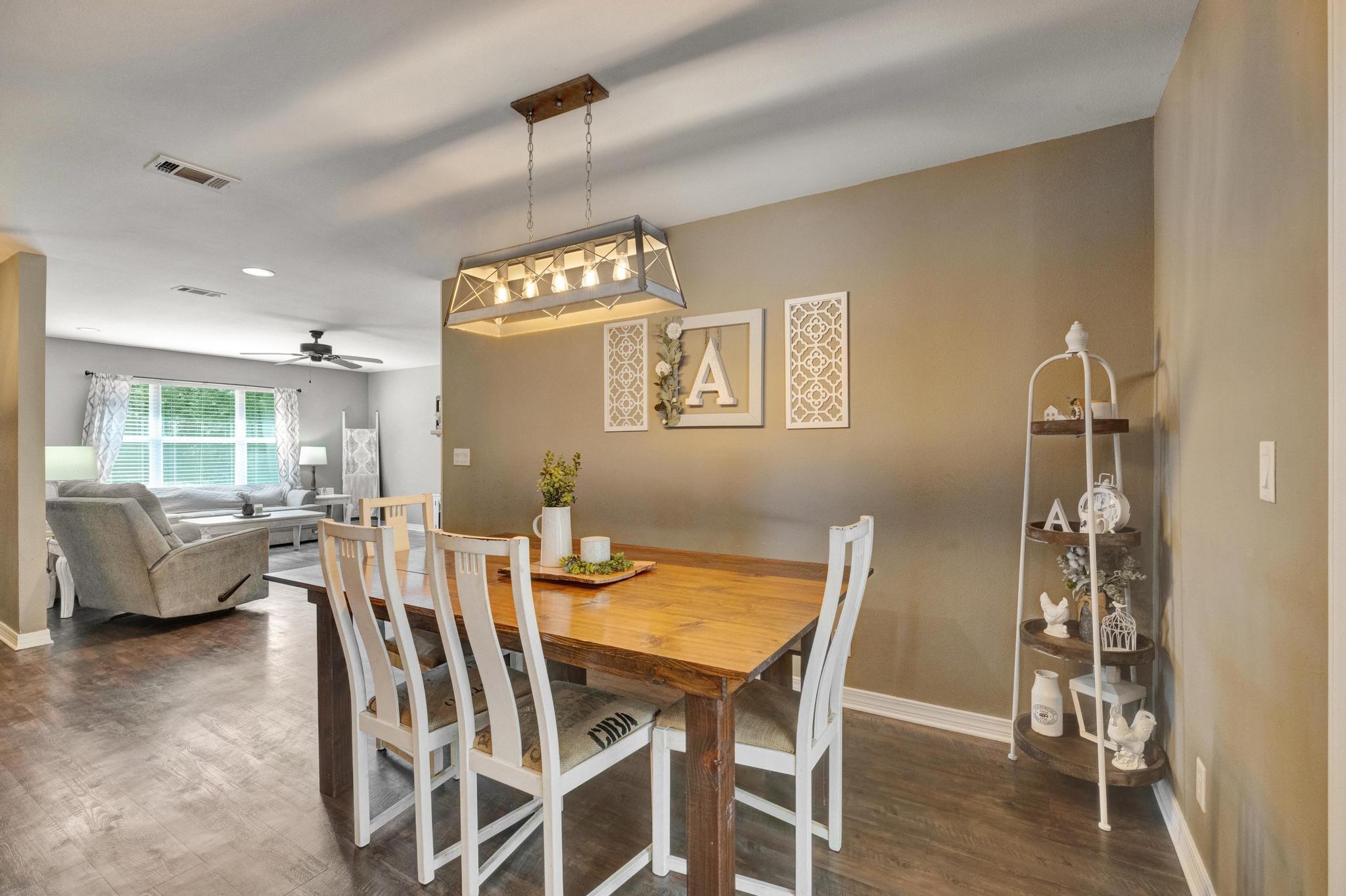 1141 Country Living Road Baker, FL 32531 - Photo 11 of 60 a view of a dining room with furniture and wooden floor