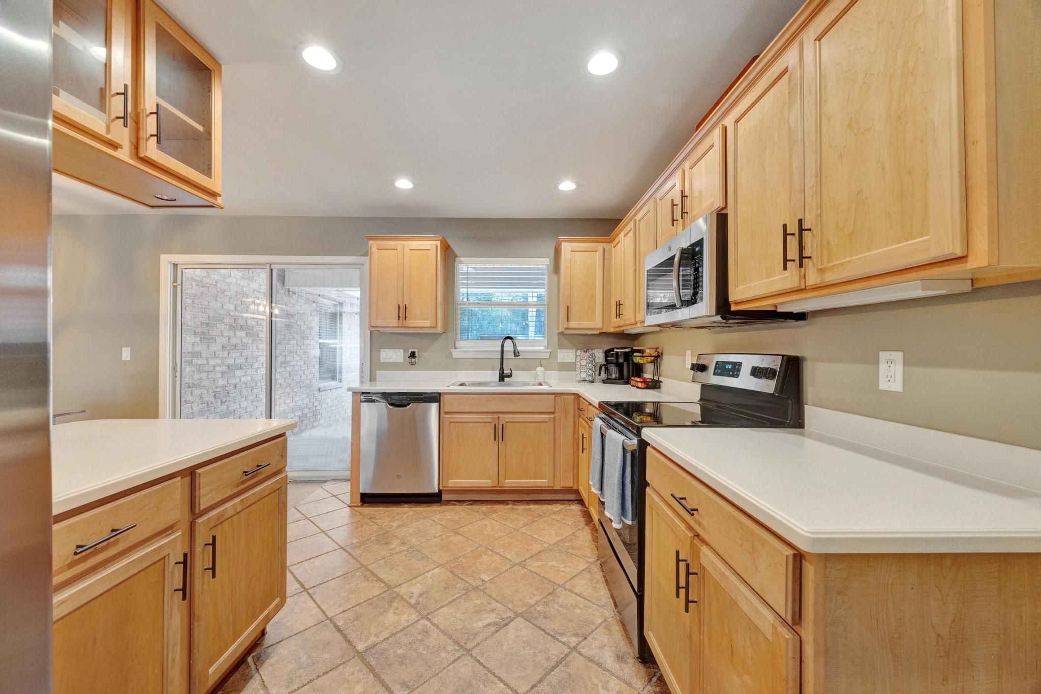 1141 Country Living Road Baker, FL 32531 - Photo 20 of 60 a kitchen with a sink window and cabinets