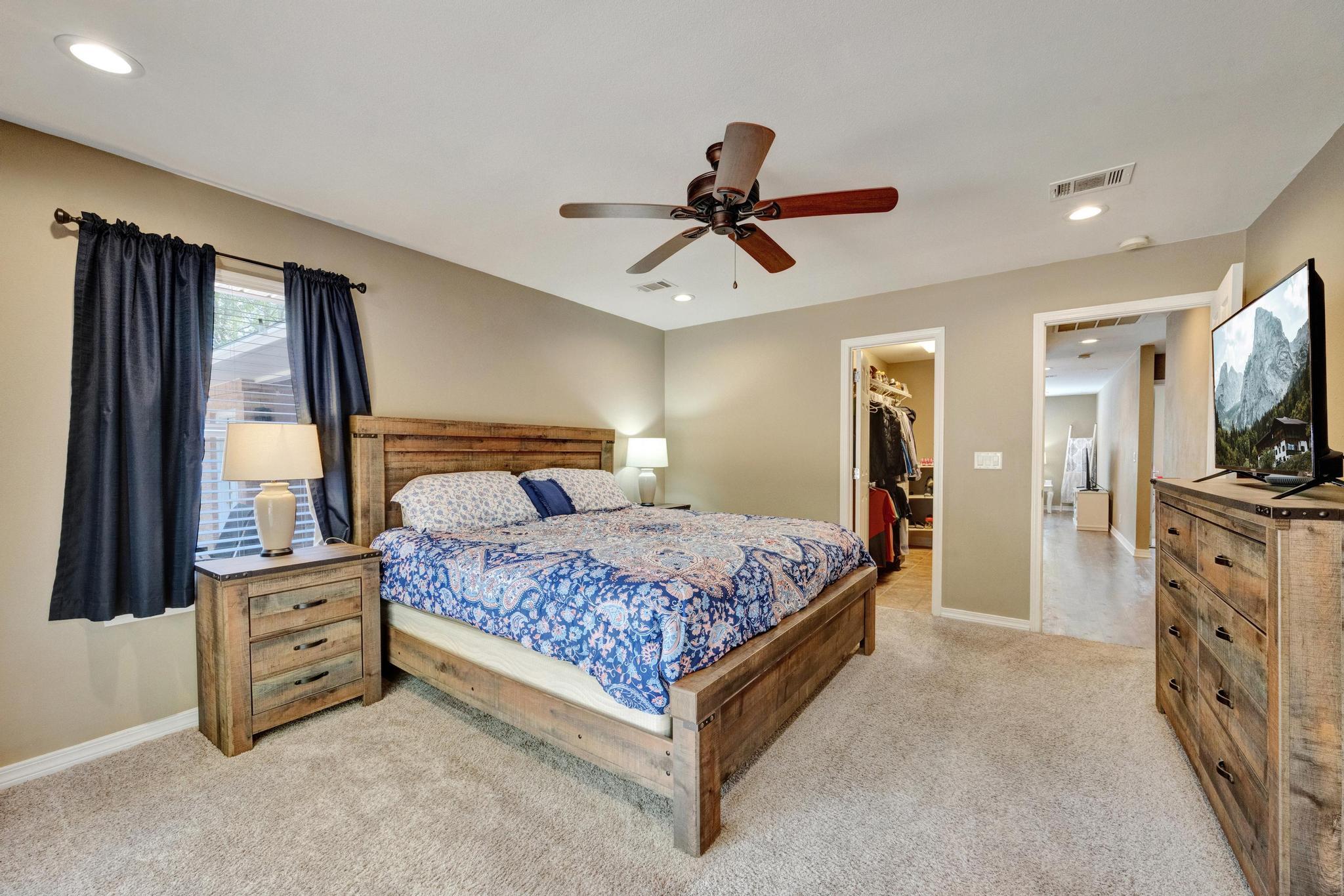 1141 Country Living Road Baker, FL 32531 - Photo 25 of 60 a bedroom with a bed a dresser and flat screen tv