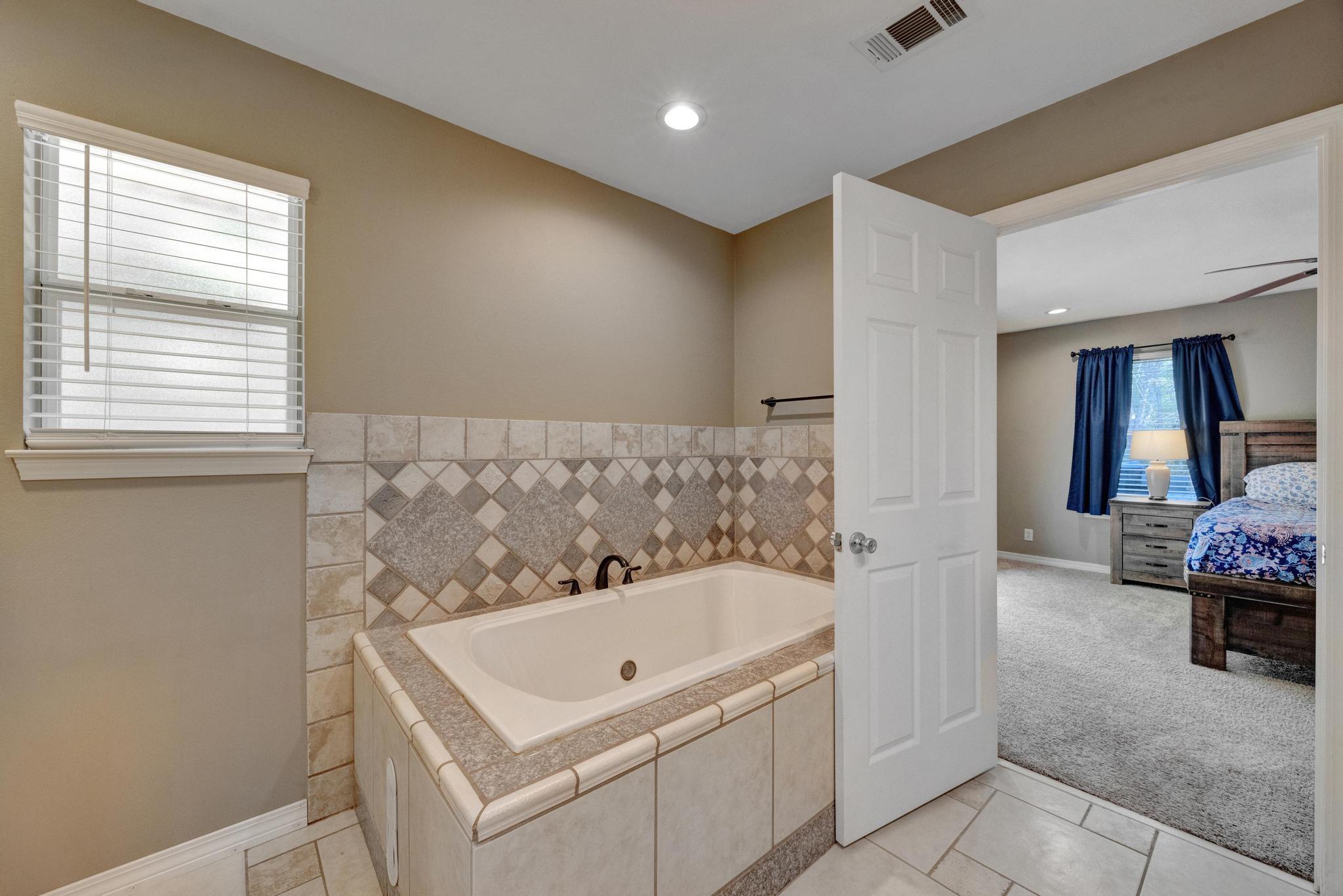 1141 Country Living Road Baker, FL 32531 - Photo 29 of 60 a bath room with a bath tub and a sink